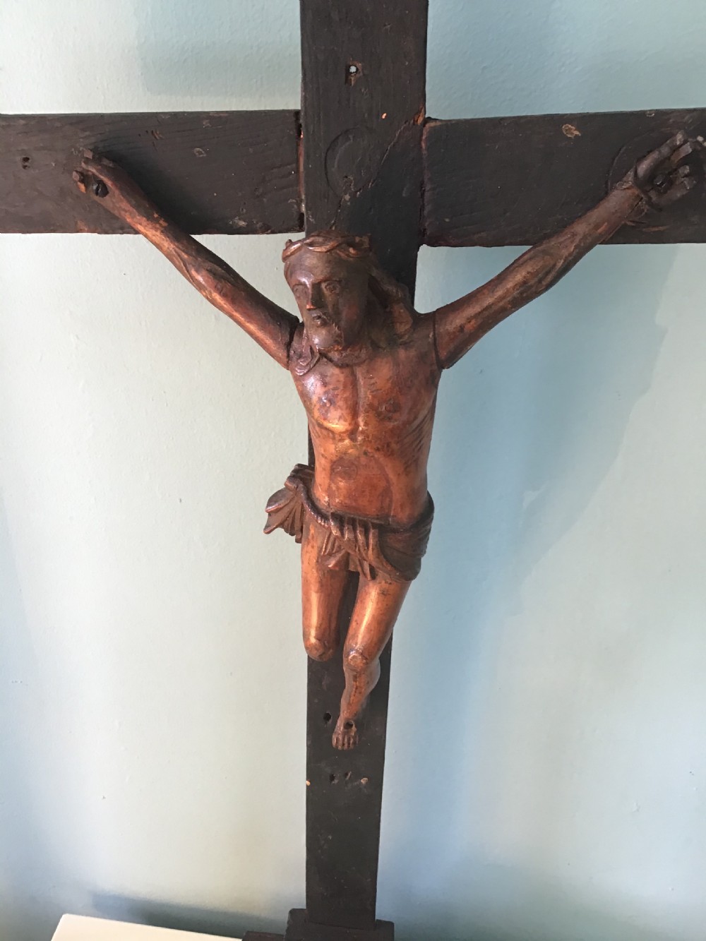 A hand-carved wooden standing crucifix featuring a detailed Corpus Christi figure mounted on a dark ebonised wooden cross with a tiered base. View II
