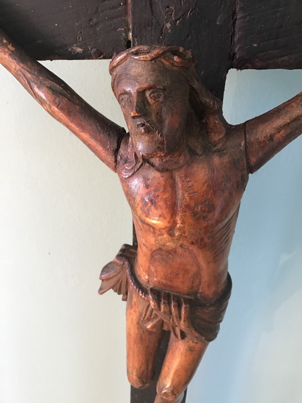 A hand-carved wooden standing crucifix featuring a detailed Corpus Christi figure mounted on a dark ebonised wooden cross with a tiered base. View III