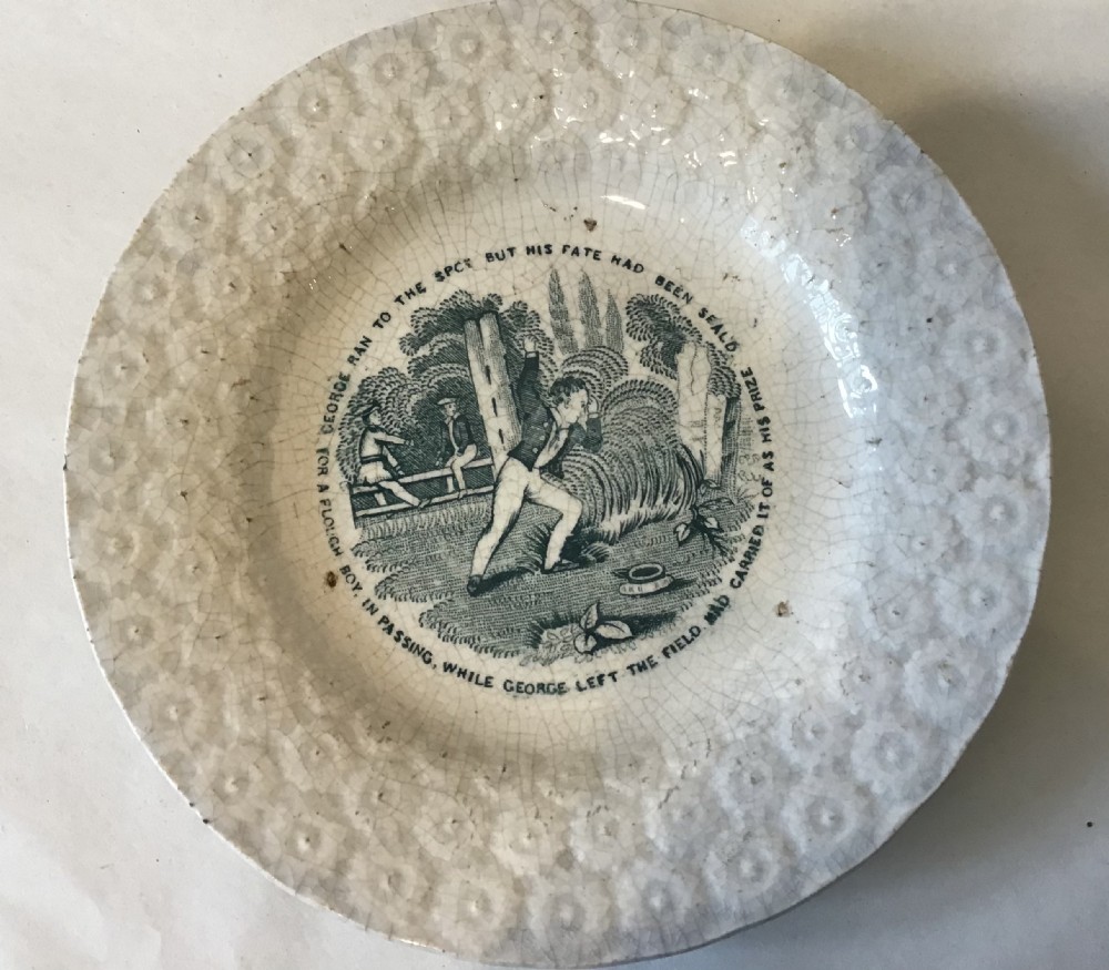 A circular off-white pearlware plate with a moulded floral rim and a central dark green transfer print depicting a boy in a field surrounded by text.