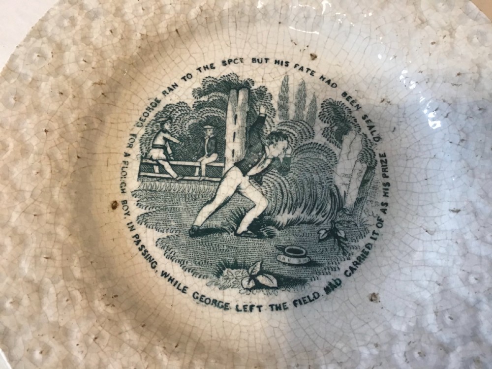 A circular off-white pearlware plate with a moulded floral rim and a central dark green transfer print depicting a boy in a field surrounded by text. View III
