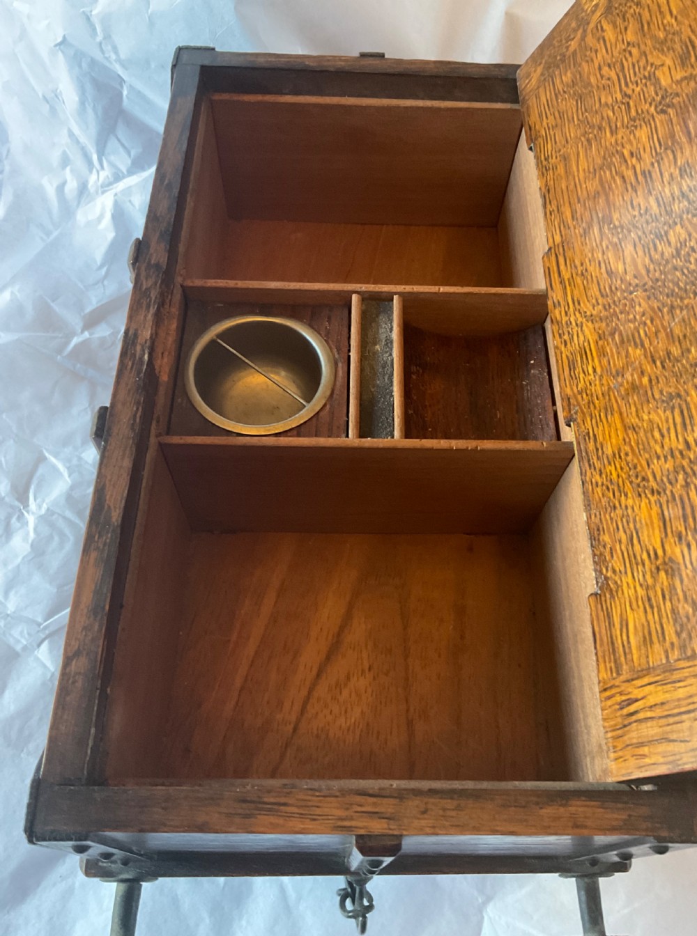 An antique Victorian oak cigar humidor constructed in the shape of a railway coal wagon with metal wheels, side bracing, and faux coal lining the top. View IX