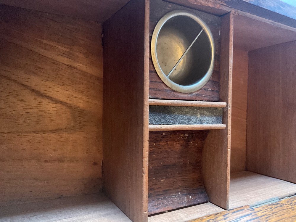 An antique Victorian oak cigar humidor constructed in the shape of a railway coal wagon with metal wheels, side bracing, and faux coal lining the top. View XI