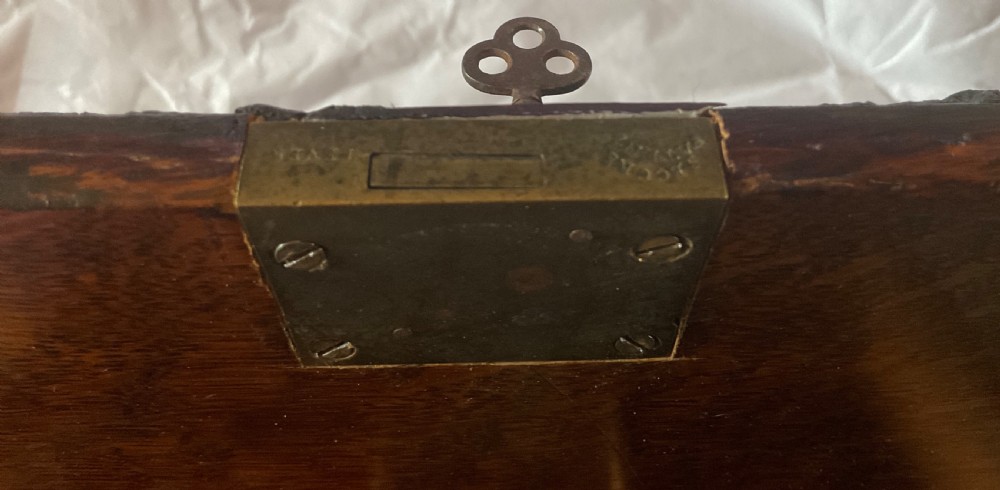 An antique Victorian oak cigar humidor constructed in the shape of a railway coal wagon with metal wheels, side bracing, and faux coal lining the top. View XIII