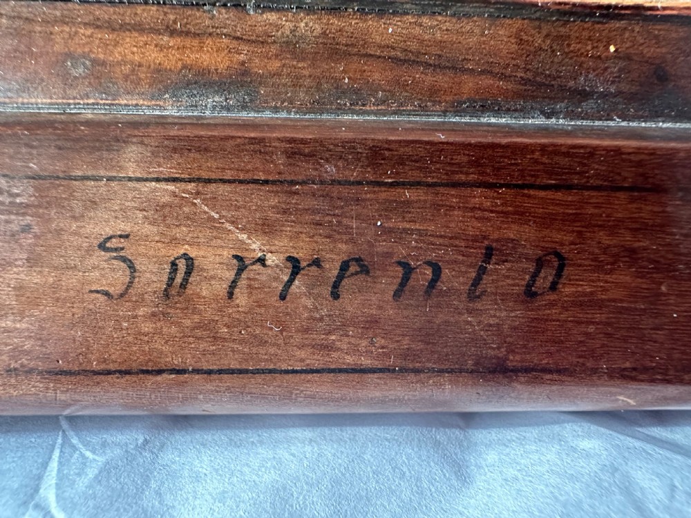A rectangular olive wood folding travel mirror featuring a central oval marquetry panel with inlaid figures and Sorrento lettering. View III