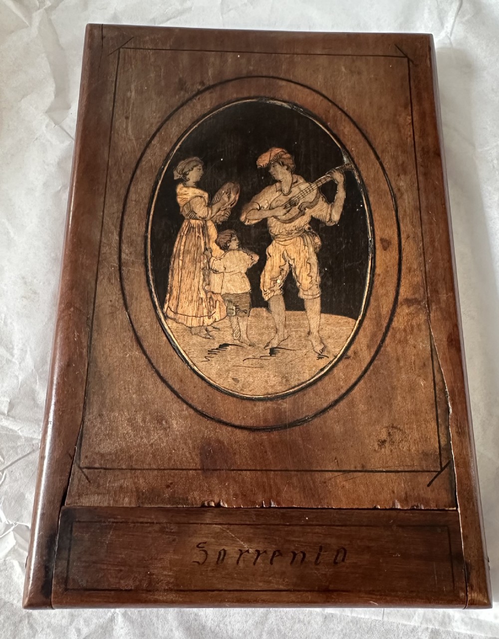 A rectangular olive wood folding travel mirror featuring a central oval marquetry panel with inlaid figures and Sorrento lettering. View IV