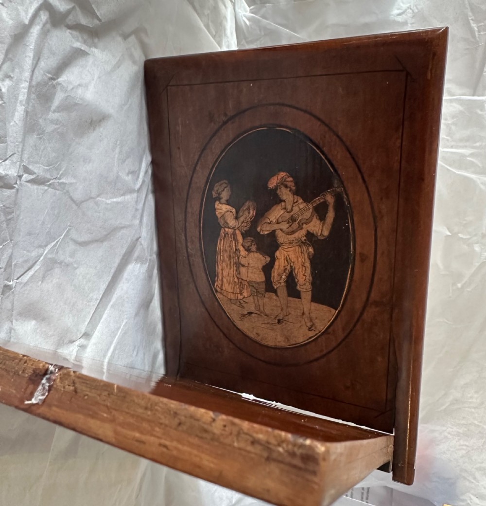 A rectangular olive wood folding travel mirror featuring a central oval marquetry panel with inlaid figures and Sorrento lettering. View V
