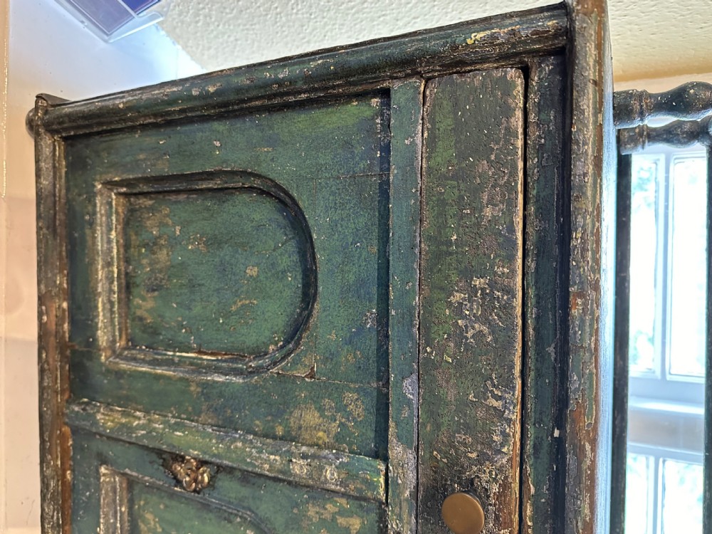 An antique French dark green painted miniature dresser featuring a tiered spindle plate rack above a single drawer and twin arched panel cupboard doors. View III