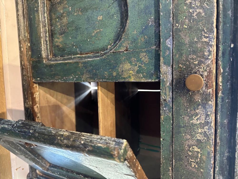 An antique French dark green painted miniature dresser featuring a tiered spindle plate rack above a single drawer and twin arched panel cupboard doors. View V