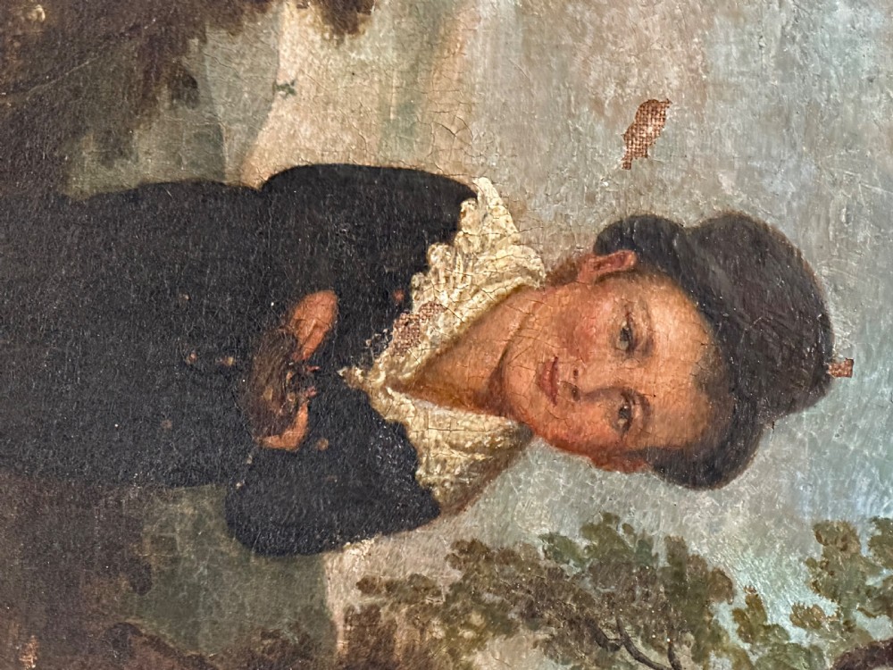 An antique naive oil painting depicting a young boy in dark attire holding a bird nest within a landscape setting, enclosed in a wooden frame. View III