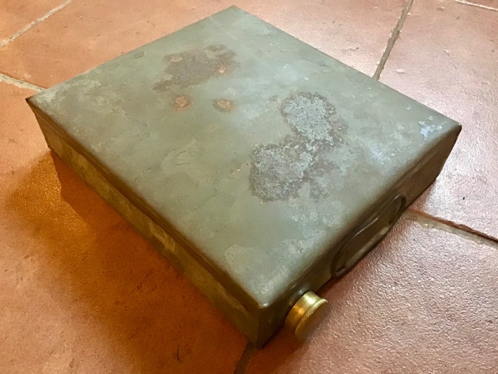 An antique Victorian carriage foot warmer featuring a square patterned carpet top with stud detailing, a wooden base with turned feet, and a metal carry handle. View III