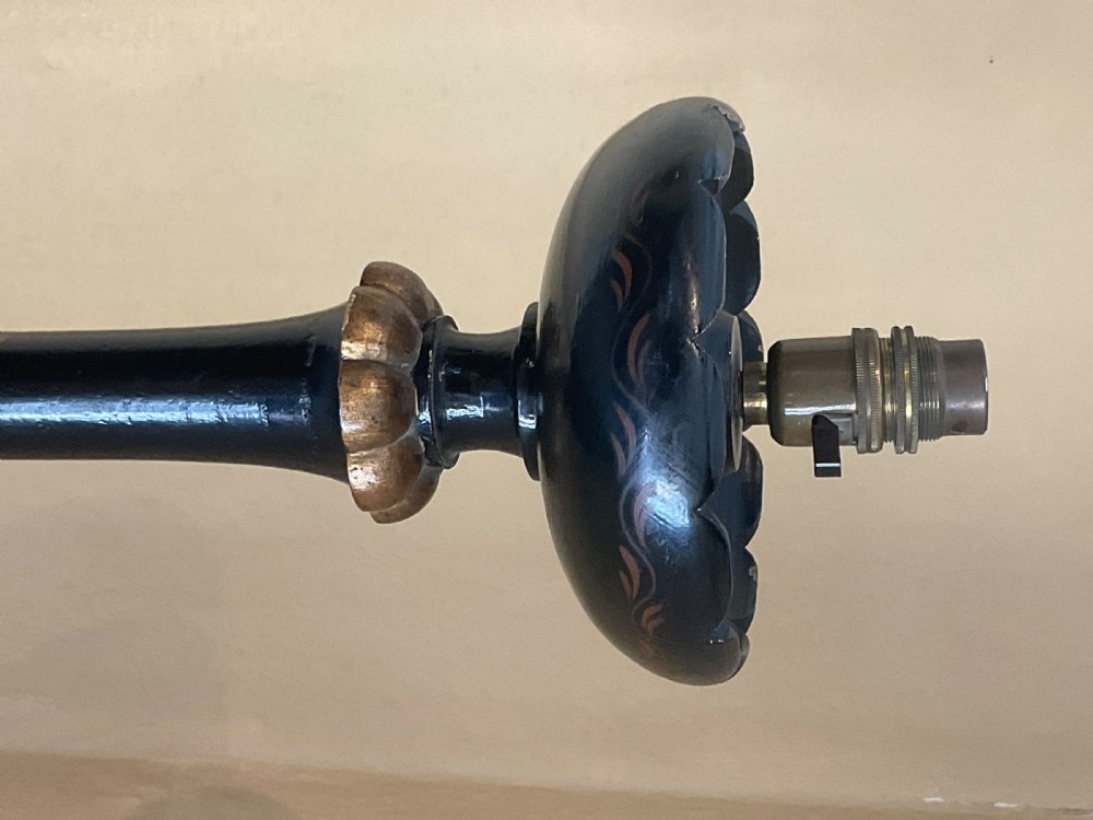 A tall black lacquered wooden standard lamp featuring Chinoiserie hand-painted gilded decoration, turned collars, a scalloped drip pan, and a circular moulded base. View II