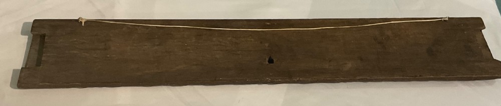 A long rectangular 17th-century carved dark oak frieze panel with repeating diagonal fluting and leaf end motifs. View VI