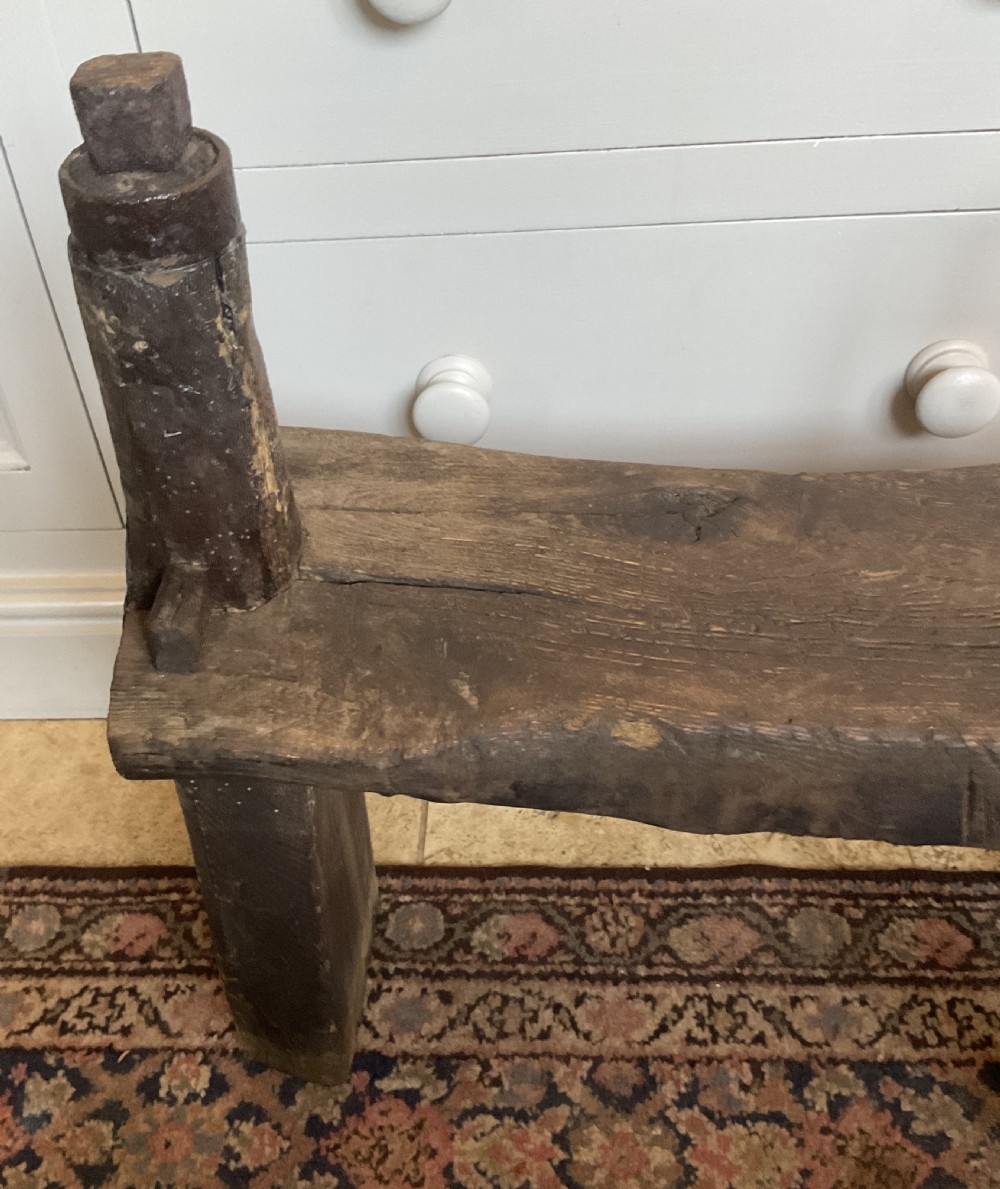A rustic dark oak cobbler bench featuring a thick timber top with integrated iron tools and sturdy wooden leg supports. View II