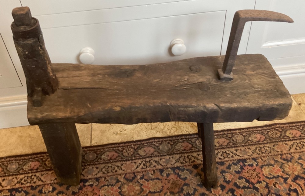 A rustic dark oak cobbler bench featuring a thick timber top with integrated iron tools and sturdy wooden leg supports. View VIII