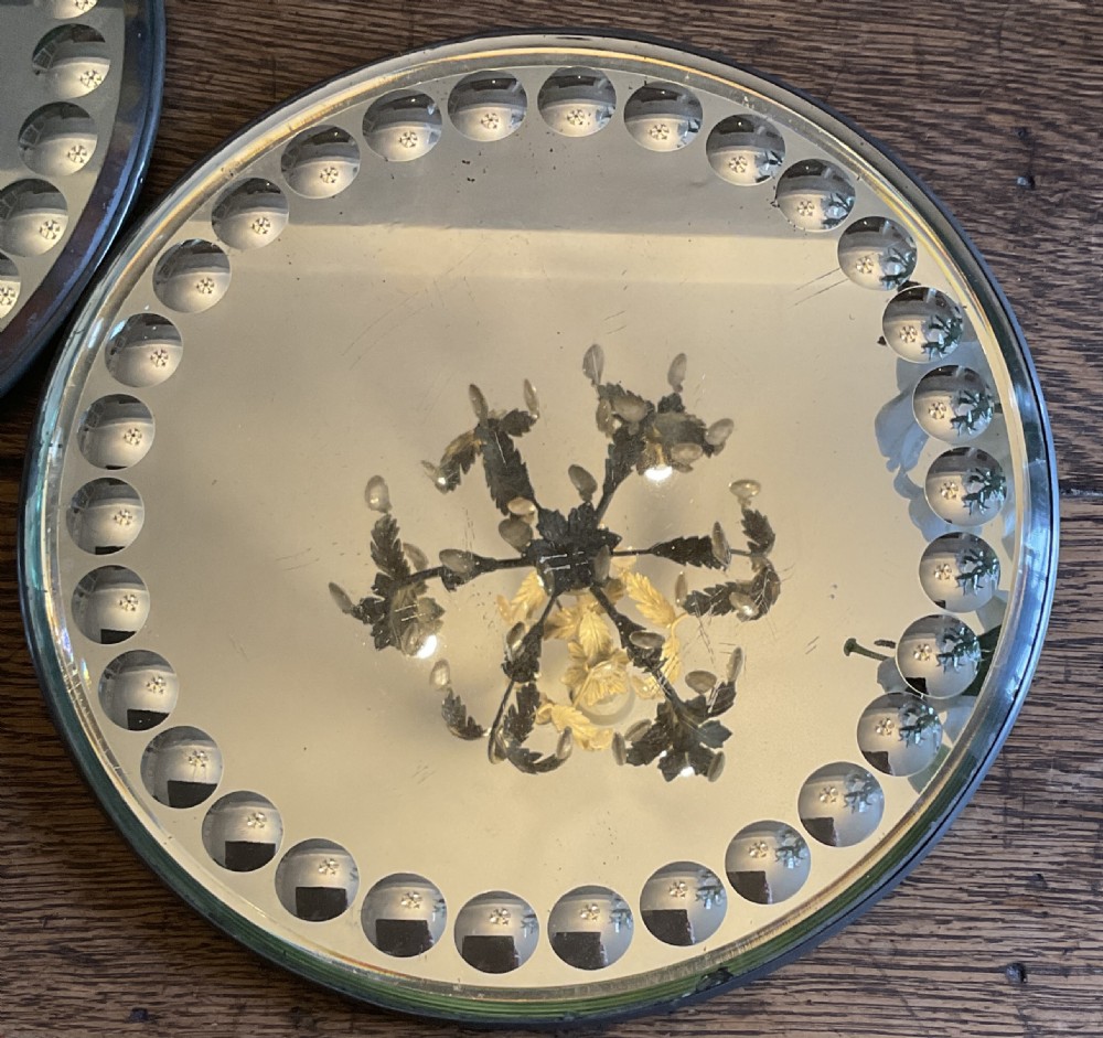 A collection of five circular convex sorcerer mirrors featuring beaded glass border detailing. View VII