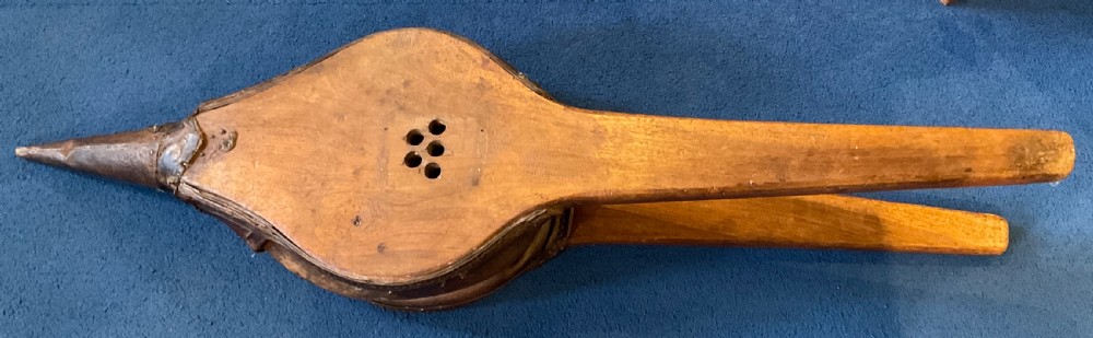 Antique French wooden fireplace bellows featuring dark leather trim, metal nozzle, and maker stamp printed on the wooden body. View III