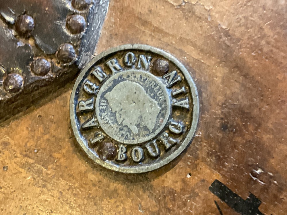 Antique French wooden fireplace bellows featuring dark leather trim, metal nozzle, and maker stamp printed on the wooden body. View X