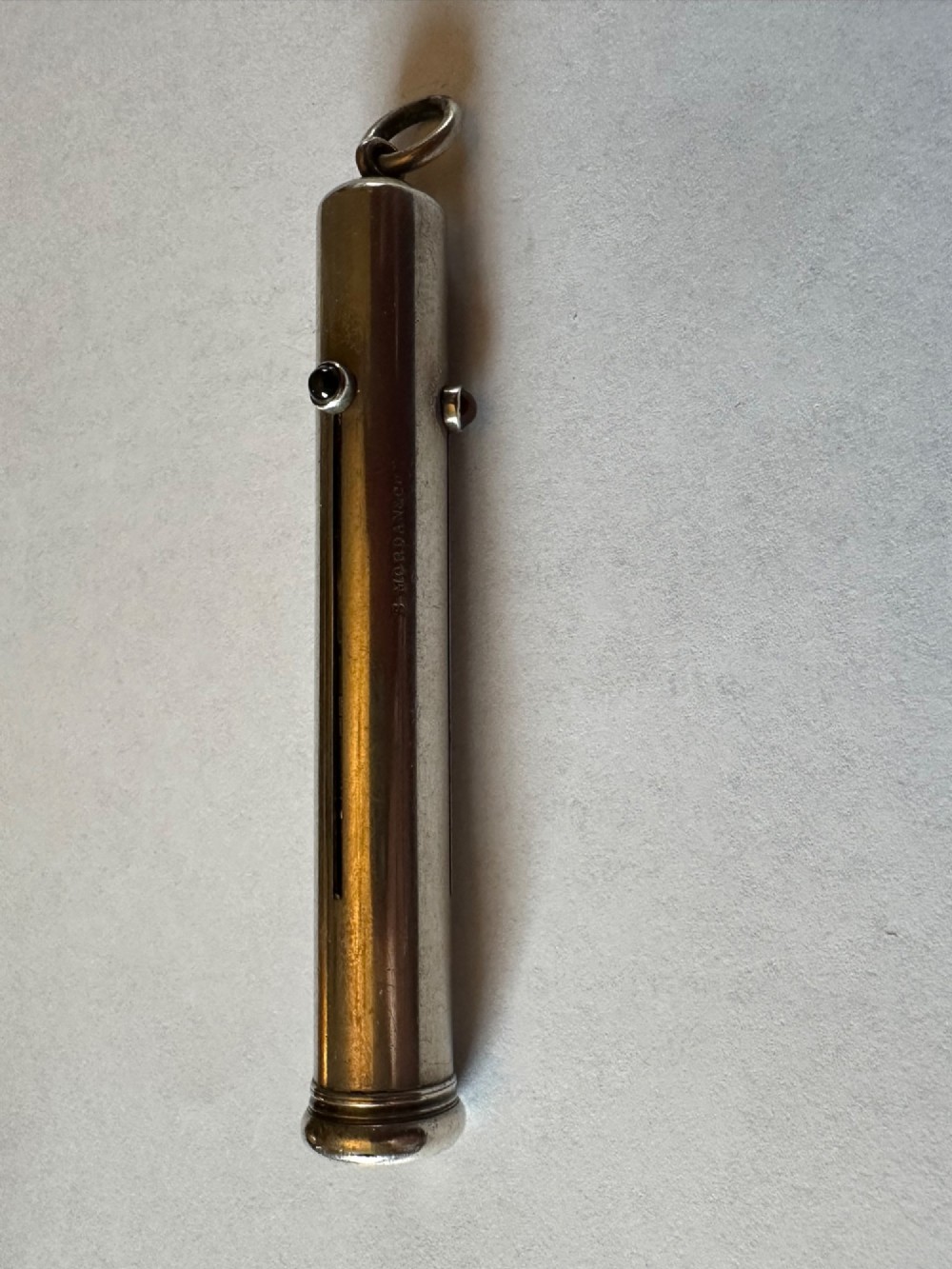 An antique Sampson Mordan sterling silver three-colour propelling pencil featuring side slider mechanisms and a top suspension ring. View II