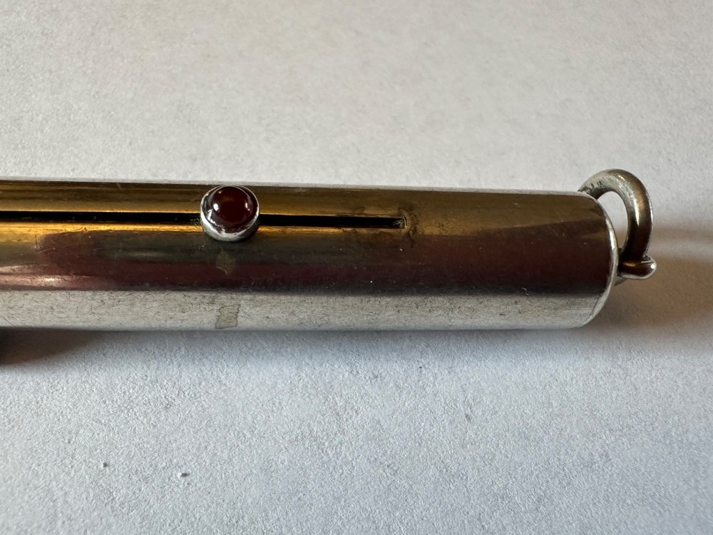 An antique Sampson Mordan sterling silver three-colour propelling pencil featuring side slider mechanisms and a top suspension ring. View IV