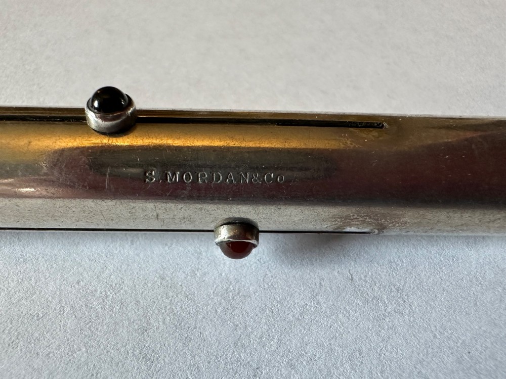 An antique Sampson Mordan sterling silver three-colour propelling pencil featuring side slider mechanisms and a top suspension ring. View V