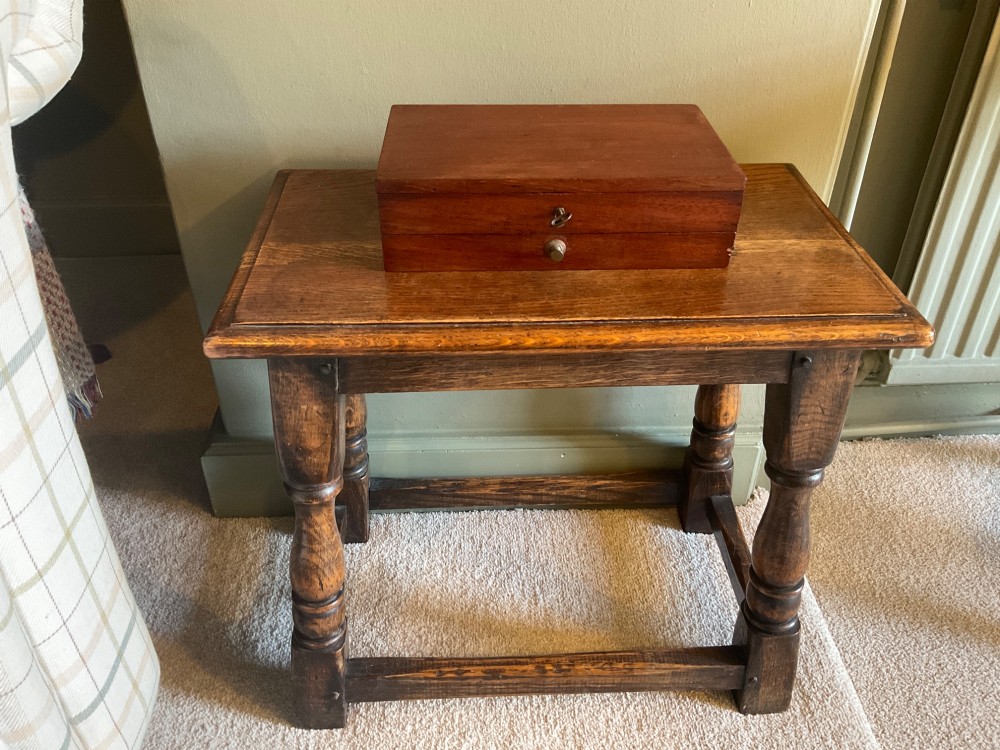 An open Victorian mahogany artist box featuring a gold-printed trade label inside the lid, fitted compartments containing watercolour blocks, and ceramic mixing dishes. View II