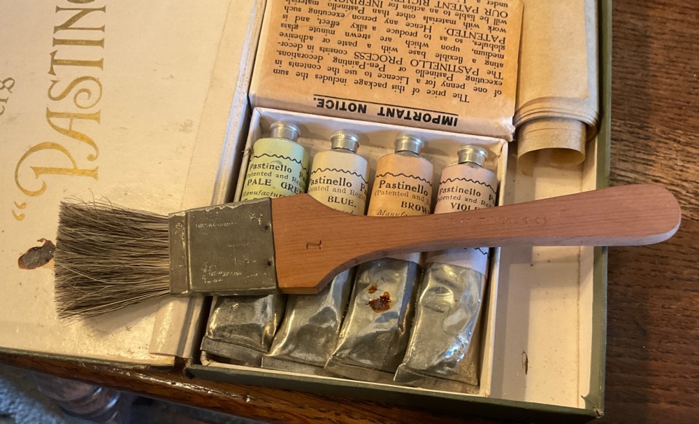 An open early 20th-century Workers Pastinello Outfit cardboard box containing paint tubes, a broad brush, and paper instructions. View VI