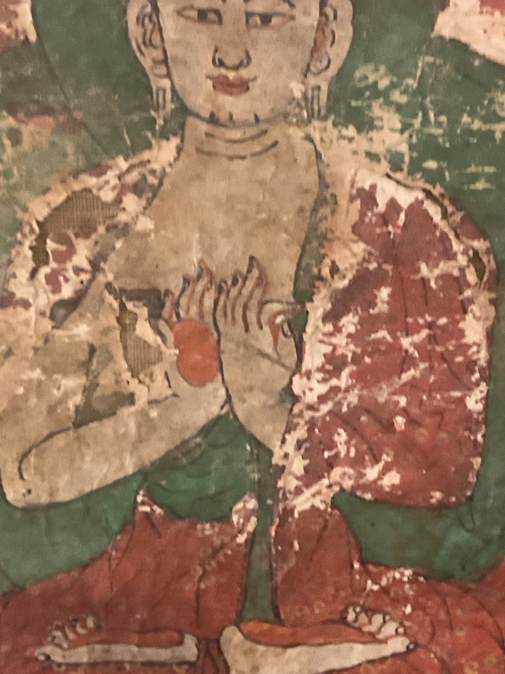 Framed 17th-century Tibetan canvas painting depicting the seated Vairocana Buddha with a red and green halo. View III