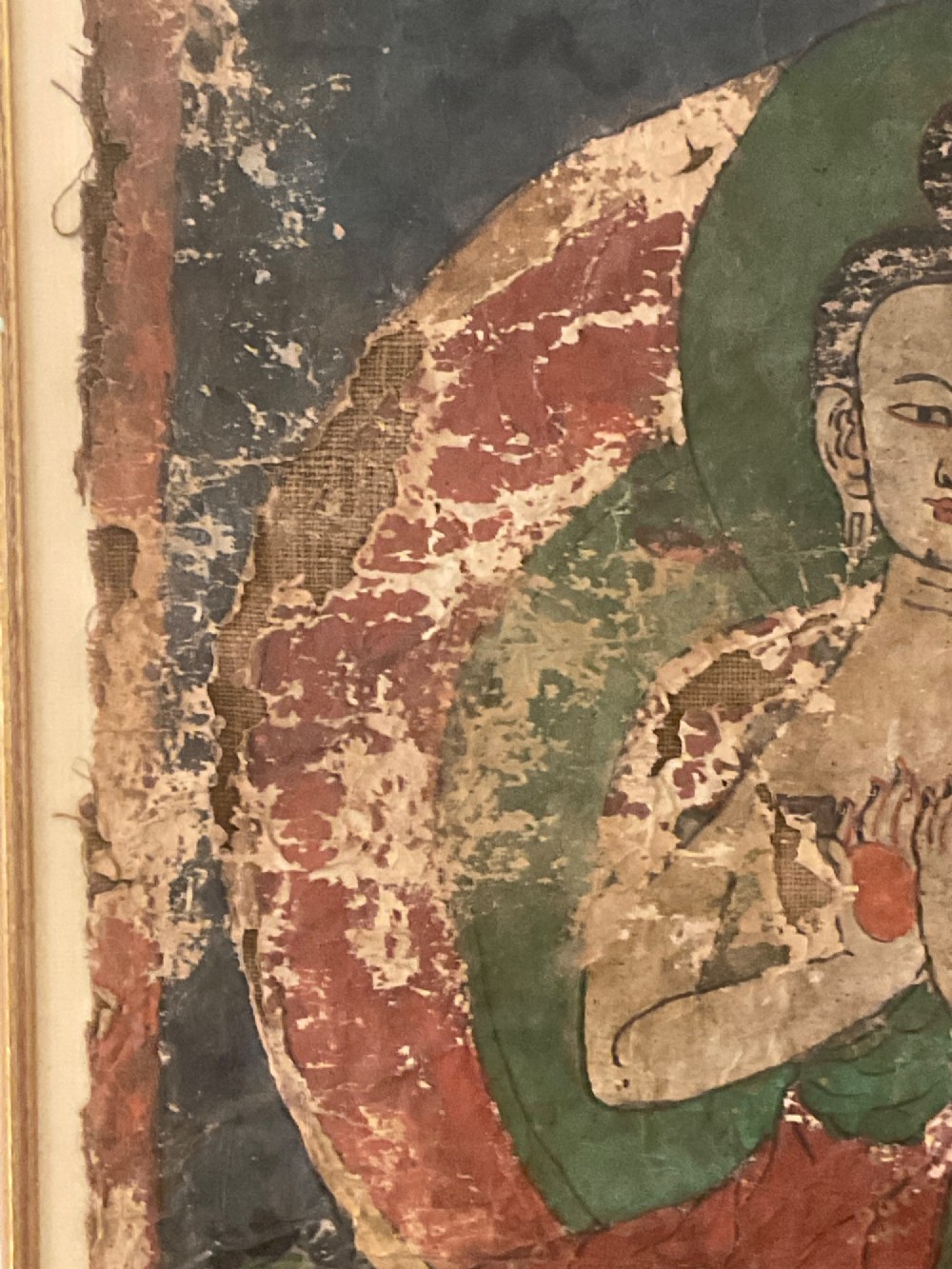 Framed 17th-century Tibetan canvas painting depicting the seated Vairocana Buddha with a red and green halo. View IV