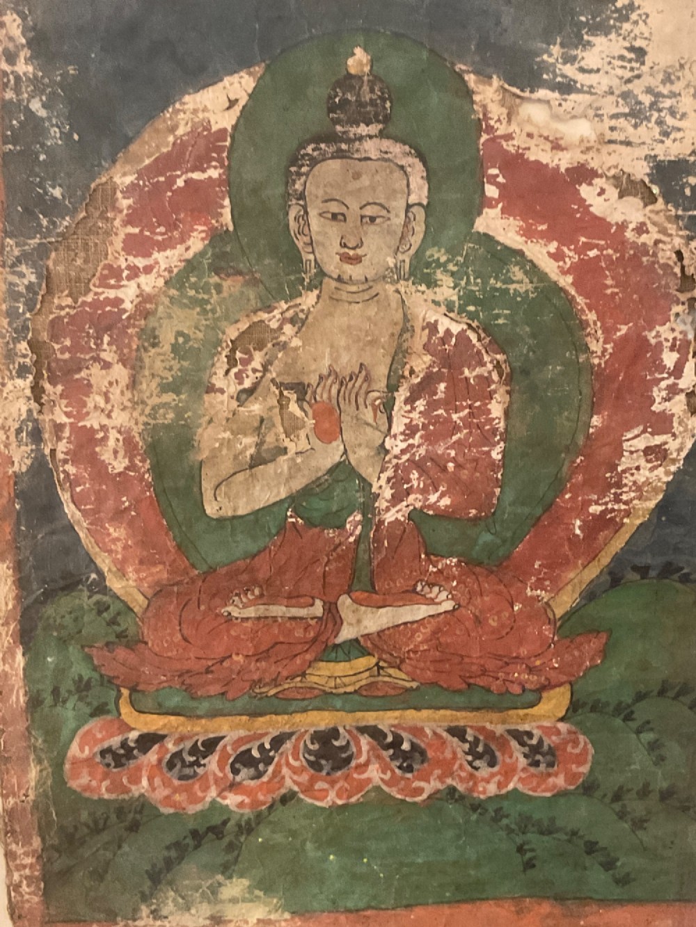 Framed 17th-century Tibetan canvas painting depicting the seated Vairocana Buddha with a red and green halo. View VI