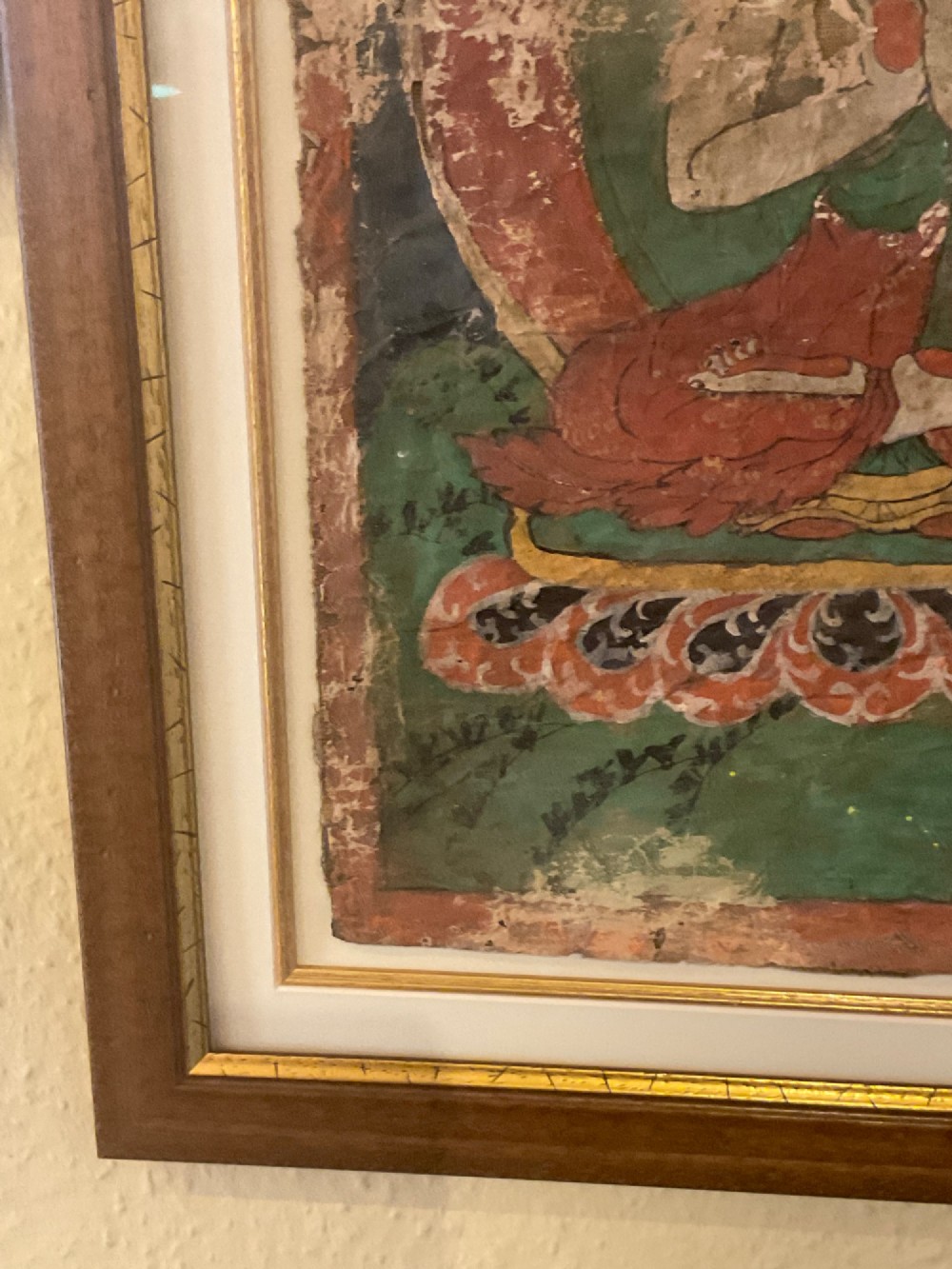 Framed 17th-century Tibetan canvas painting depicting the seated Vairocana Buddha with a red and green halo. View VII