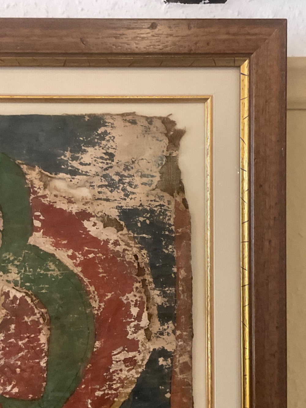 Framed 17th-century Tibetan canvas painting depicting the seated Vairocana Buddha with a red and green halo. View VIII