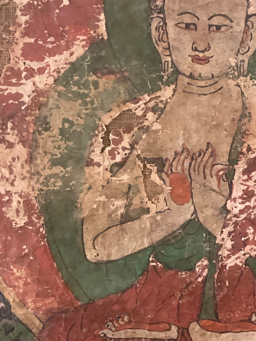 Framed 17th-century Tibetan canvas painting depicting the seated Vairocana Buddha with a red and green halo. View IX