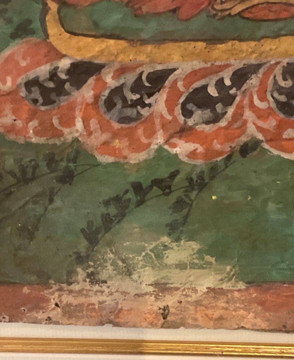 Framed 17th-century Tibetan canvas painting depicting the seated Vairocana Buddha with a red and green halo. View X