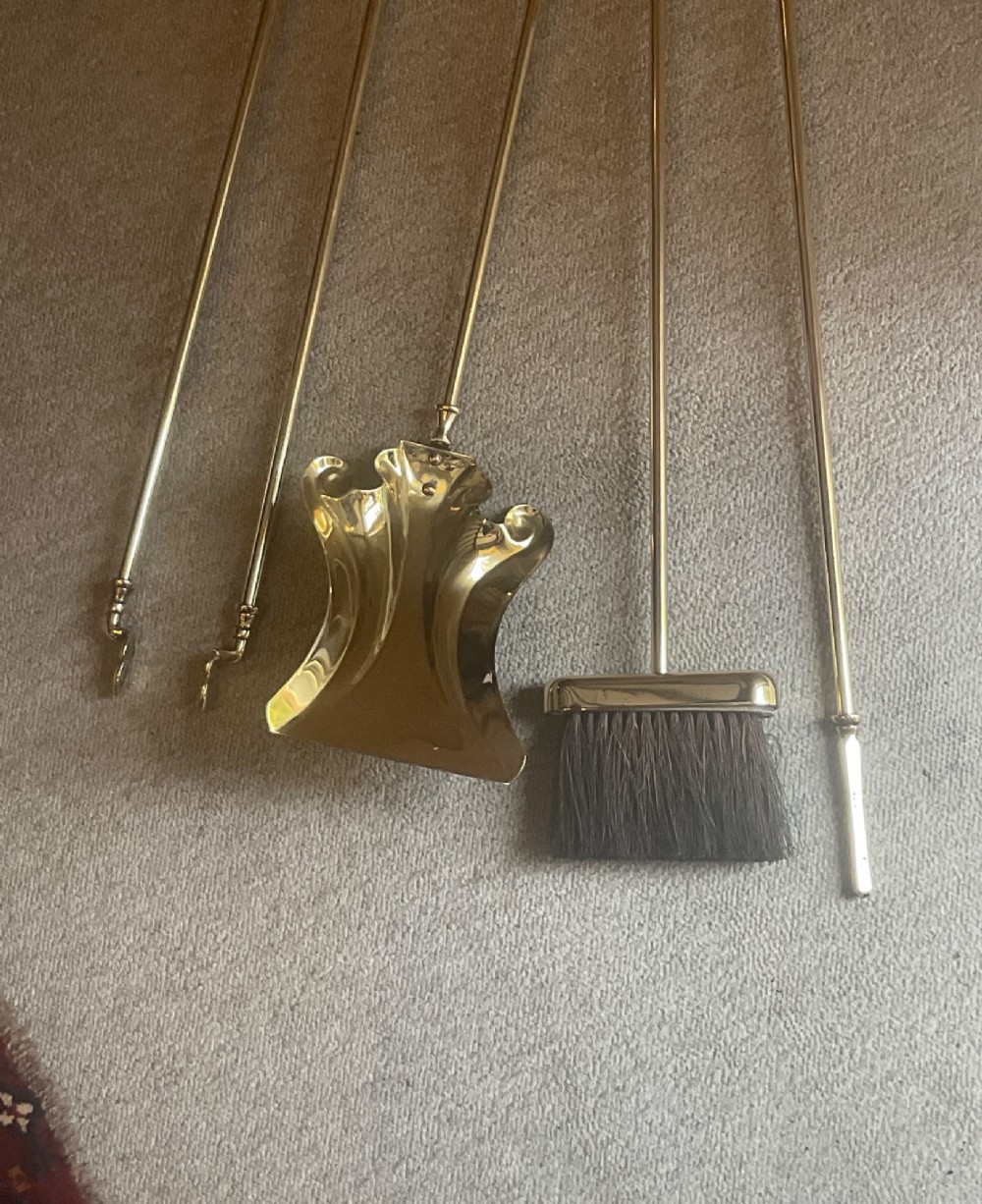 A polished brass companion set featuring a central stand with sphere finials holding a shovel, tongs, poker, and hearth brush. View II
