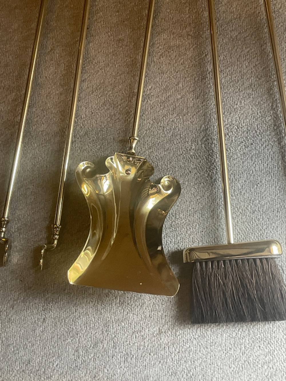 A polished brass companion set featuring a central stand with sphere finials holding a shovel, tongs, poker, and hearth brush. View III