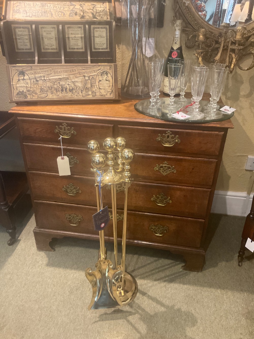 A polished brass companion set featuring a central stand with sphere finials holding a shovel, tongs, poker, and hearth brush. View VIII