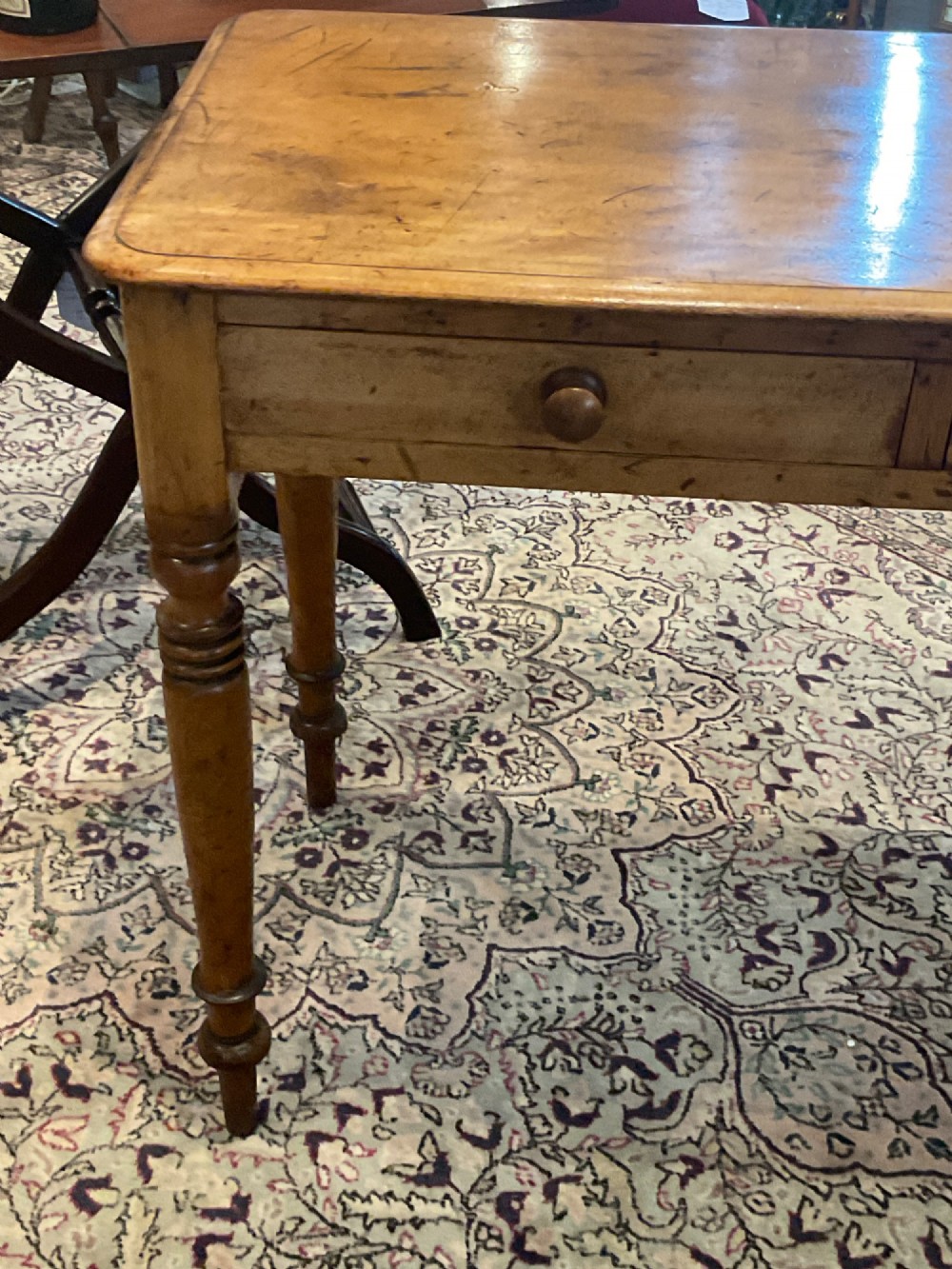 A Victorian satin walnut side table featuring two frieze drawers with wooden knob handles and four turned legs. View III