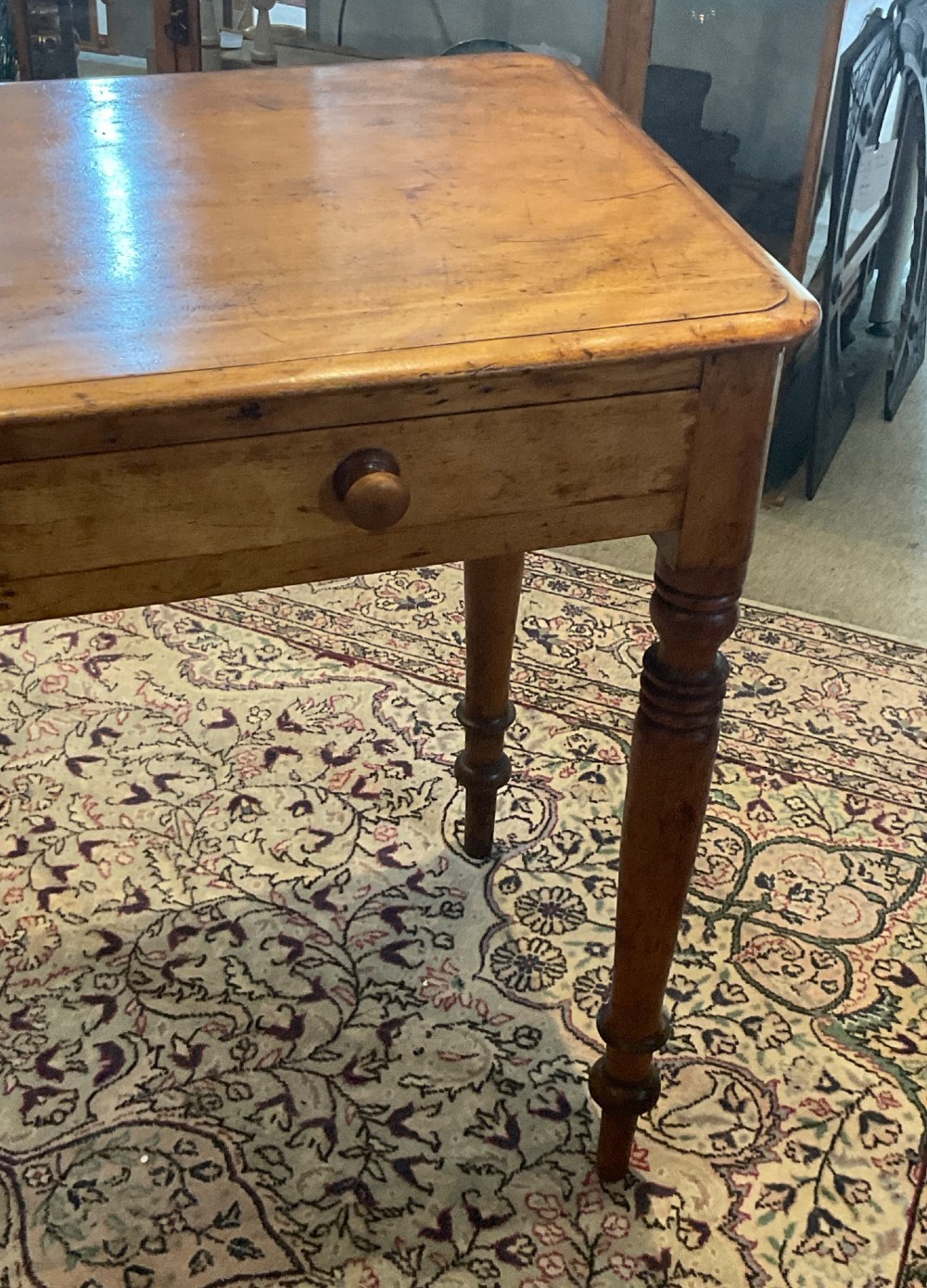 A Victorian satin walnut side table featuring two frieze drawers with wooden knob handles and four turned legs. View IV