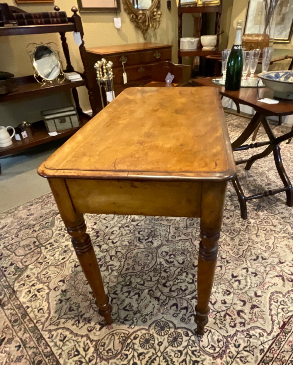 A Victorian satin walnut side table featuring two frieze drawers with wooden knob handles and four turned legs. View VIII