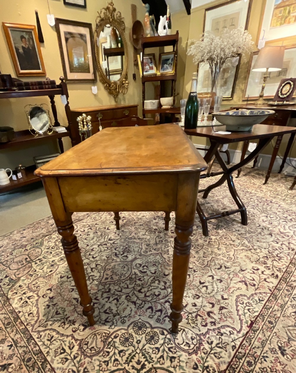 A Victorian satin walnut side table featuring two frieze drawers with wooden knob handles and four turned legs. View IX