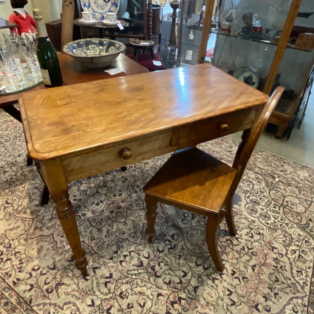 A Victorian satin walnut side table featuring two frieze drawers with wooden knob handles and four turned legs. View X