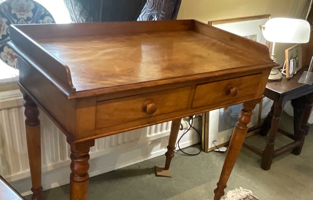 A Victorian satin birch writing desk featuring a three-quarter gallery top, two frieze drawers with turned wooden knobs, and four turned legs. View II