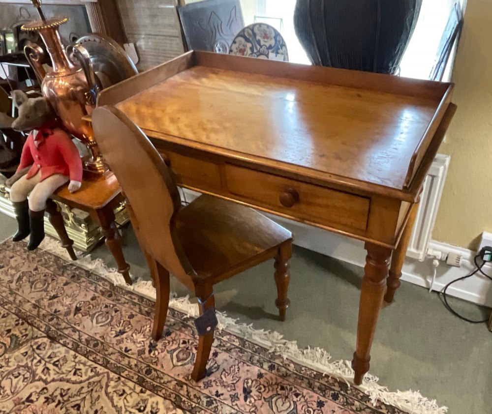 A Victorian satin birch writing desk featuring a three-quarter gallery top, two frieze drawers with turned wooden knobs, and four turned legs. View XI