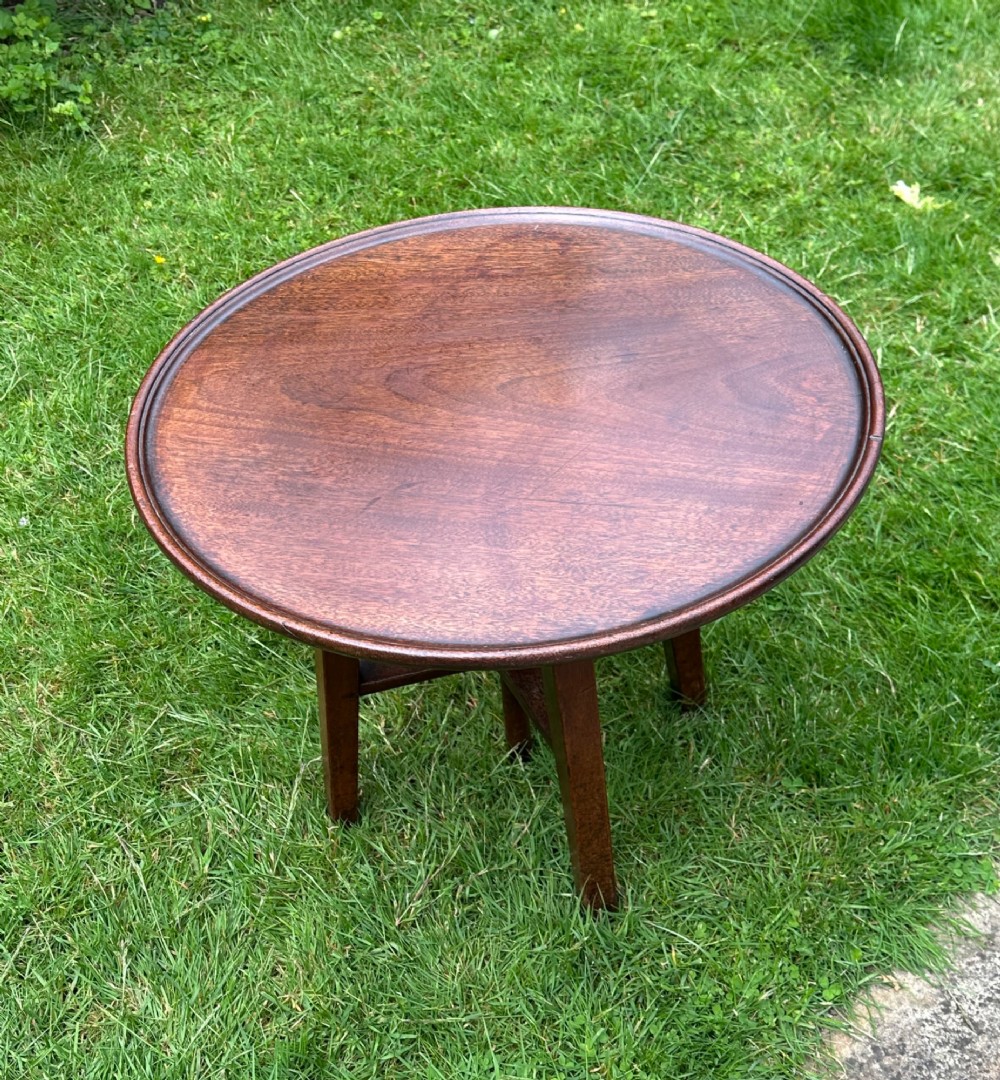 An antique round mahogany wine table with a moulded top and a threaded height-adjusting central screw resting on four legs. View II