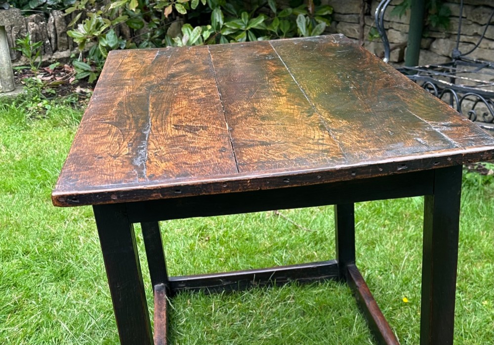 An antique dark brown oak table featuring a plank top surface, square legs, and low box stretchers. View IV