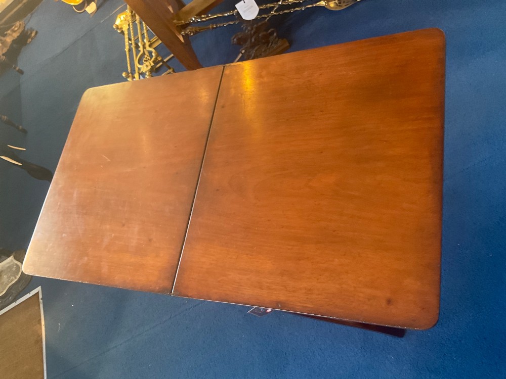 A Victorian mahogany coaching table featuring a hinged rectangular folding top supported by an X-frame base with turned stretchers. View II