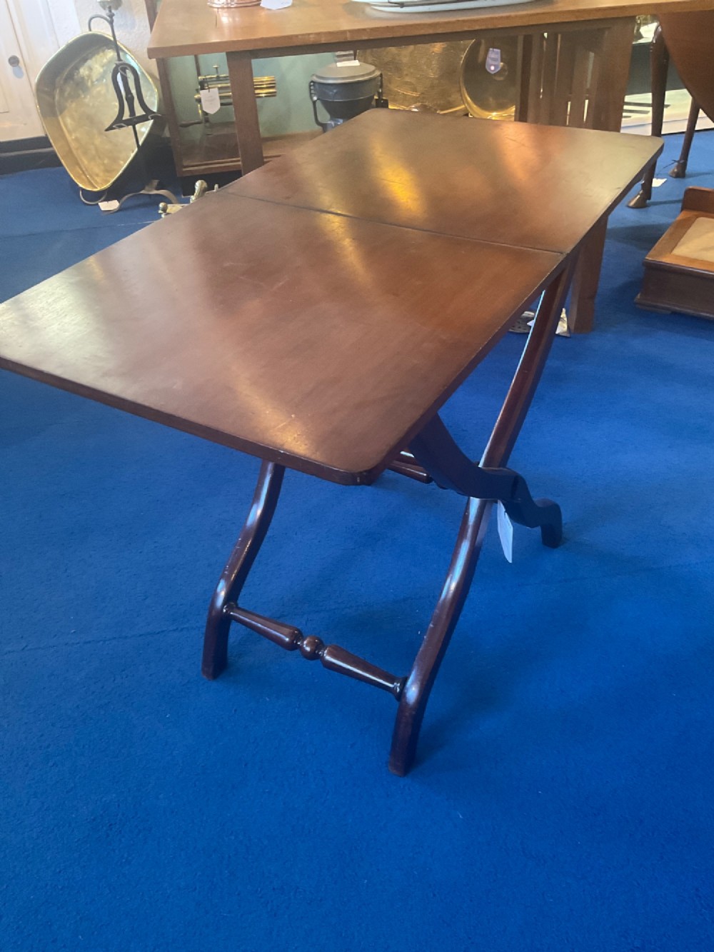 A Victorian mahogany coaching table featuring a hinged rectangular folding top supported by an X-frame base with turned stretchers. View III
