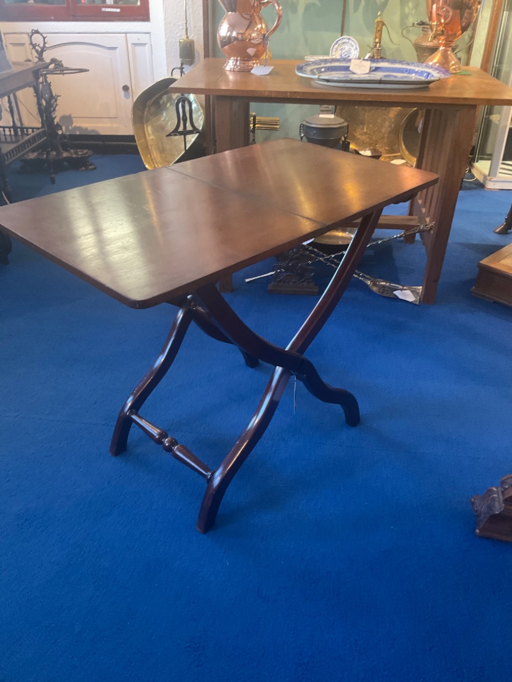 A Victorian mahogany coaching table featuring a hinged rectangular folding top supported by an X-frame base with turned stretchers. View IV