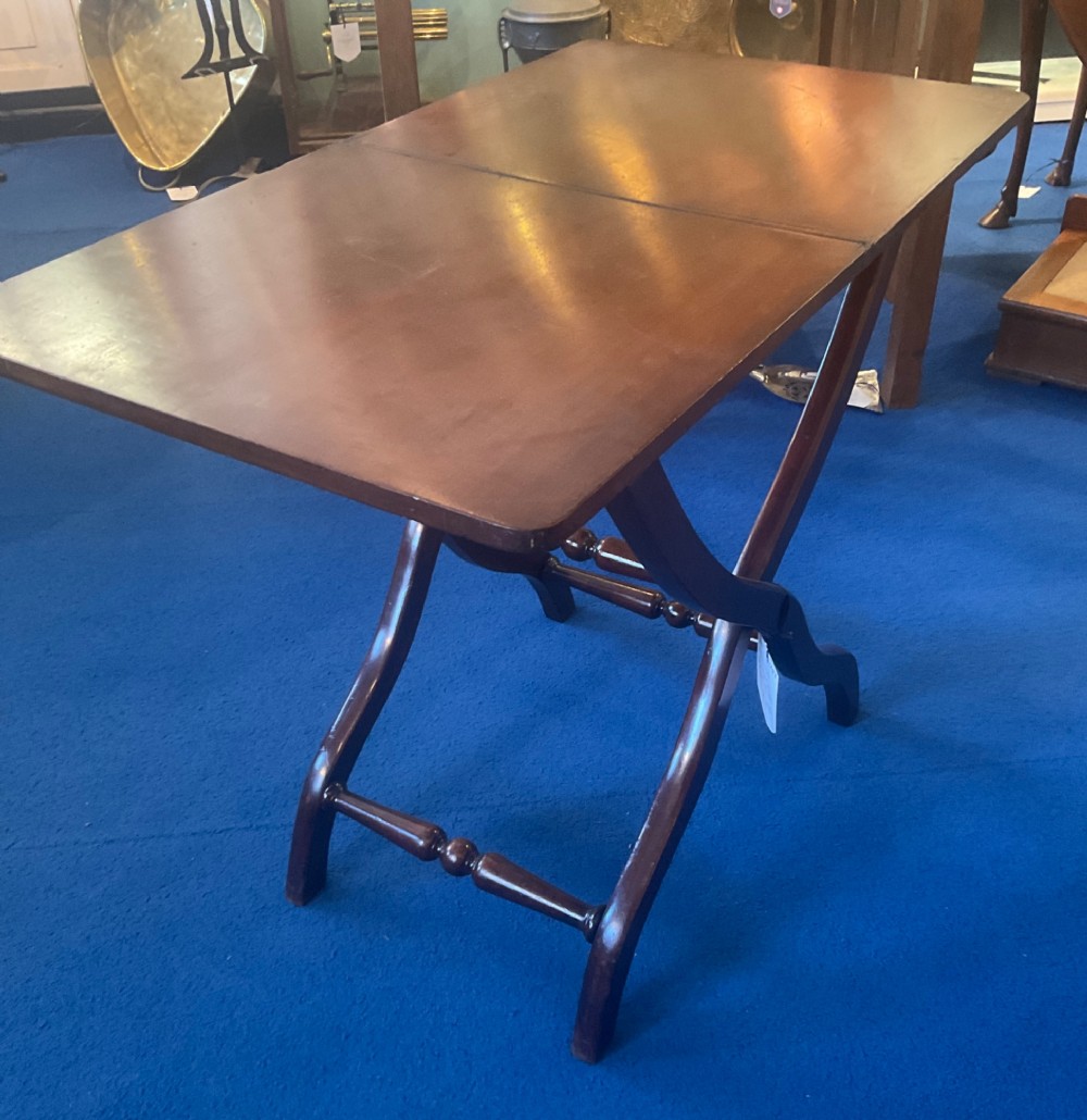 A Victorian mahogany coaching table featuring a hinged rectangular folding top supported by an X-frame base with turned stretchers. View VIII