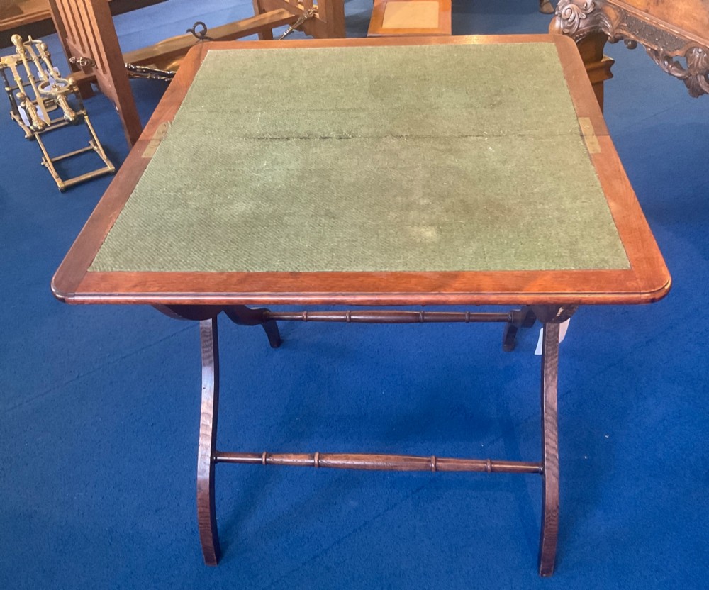 Victorian mahogany folding coaching table featuring a square green baize inset top and turned X-frame legs.